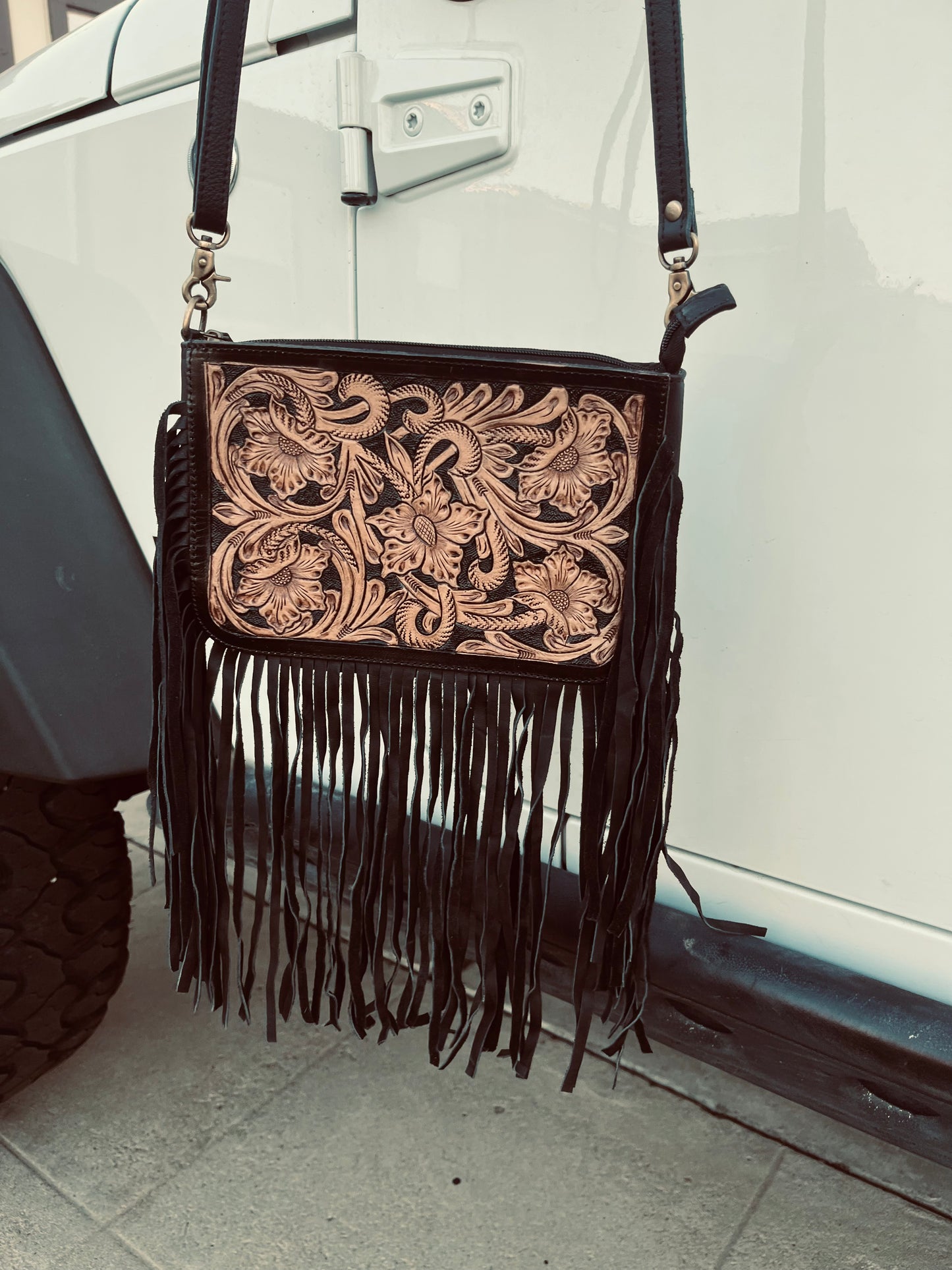 The blacked tooled crossbody