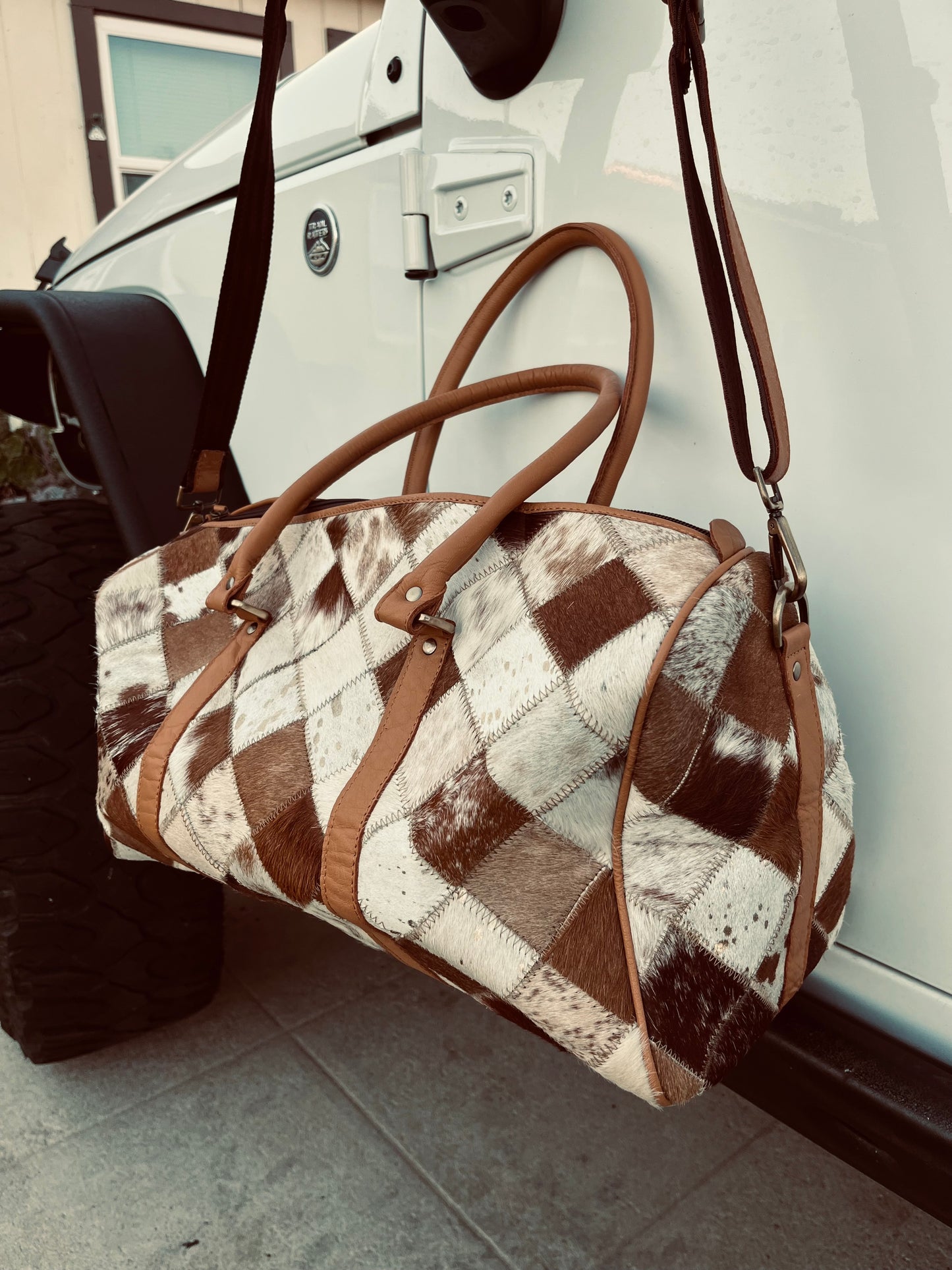 Tan+white cowhide duffel bag