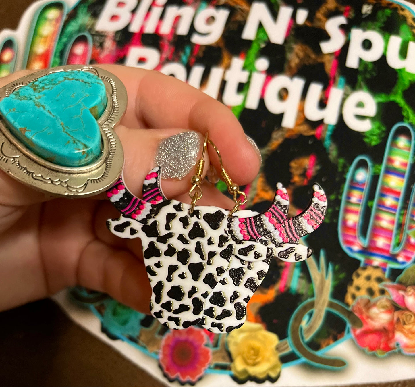 cow print long horn earrings.